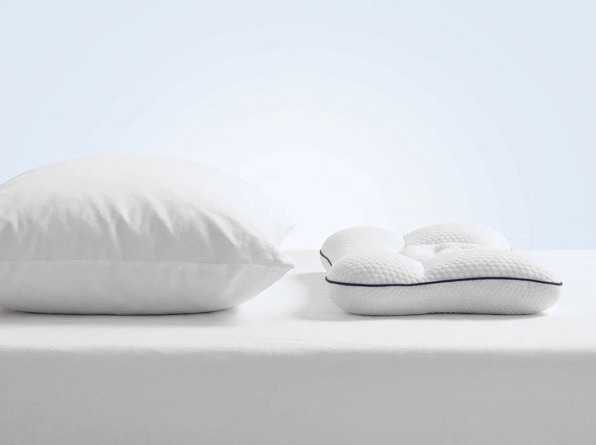 An adult pillow beside the much lower LittleBear pillow