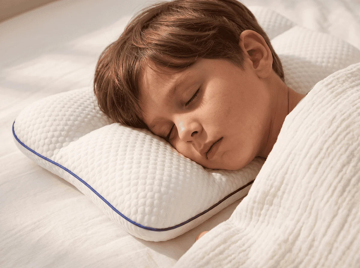 A child asleep on the LittleBear pillow with their head level